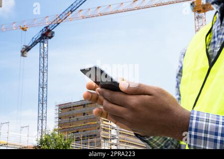 Builder Worker Using Phone Stock Photo