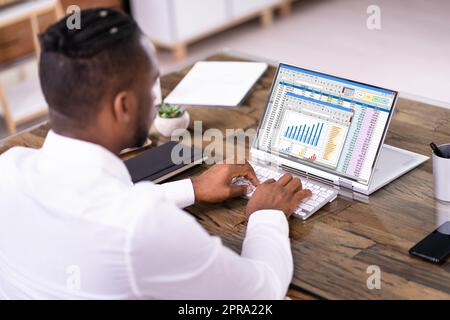 African American Man Using Spreadsheet Reports Stock Photo