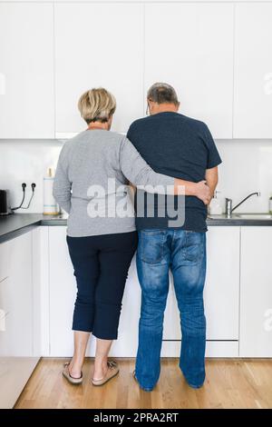 Happy romantic senior couple in love cooking at home Stock Photo