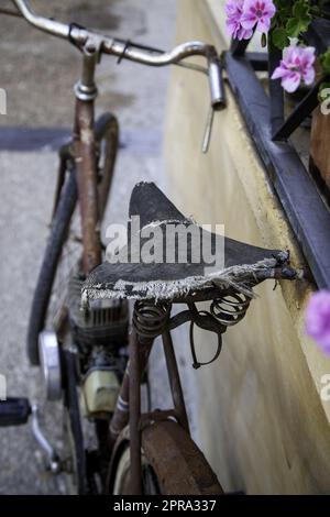 Old bicycle abandoned on the street Stock Photo