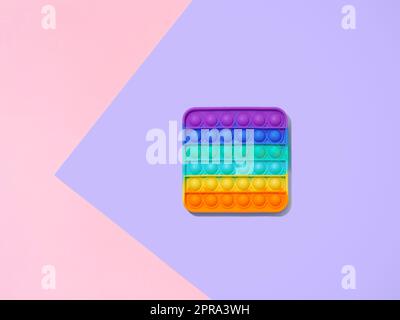 Popit toy on purple background, copy space, top view Stock Photo