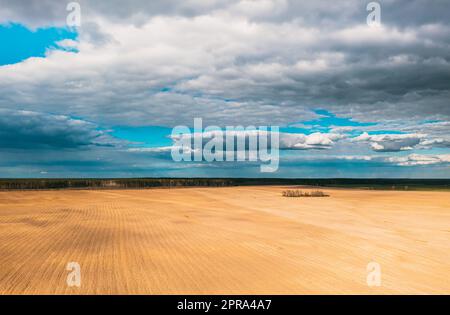 Aerial View. Amazing Natural Dramatic Sky With Rain Clouds Above Countryside Rural Field Landscape In Spring Day. Scenic Sky With Fluffy Clouds On Horizon. Beauty In Nature Stock Photo