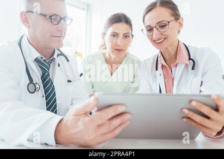Team of doctors in meeting discussing a case Stock Photo