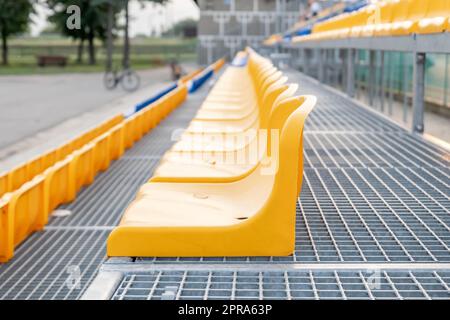 Simple empty vacant small stadium seats outdoors, bleachers, nobody, no people, cancelled sports event, nobody present at a sport show simple abstract Stock Photo