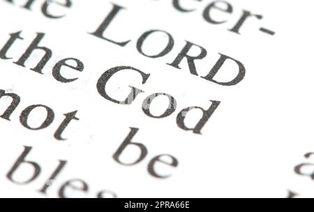 Word 'God' on a page in a book, single word macro detail closeup, zoom shot, nobody God, deity, sacrum simple abstract concept, spirituality, religion Stock Photo