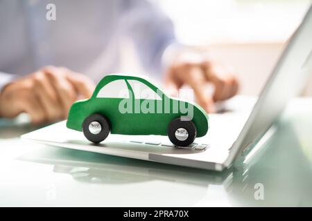 Blue Car On Laptop Keypad Stock Photo