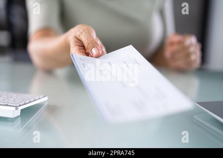 Giving Paycheck Or Payroll Cheque Stock Photo