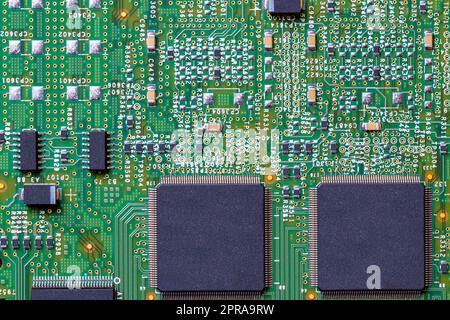 Closeup of micro processor chip on motherboard in computer. Green printed circuit board. PCB.  Computer and networking communication technology concept. Green technology background. Stock Photo