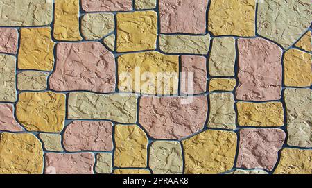 Wall made of colored stones as background Stock Photo