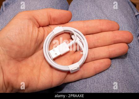 USB lightning cable  in hand Stock Photo