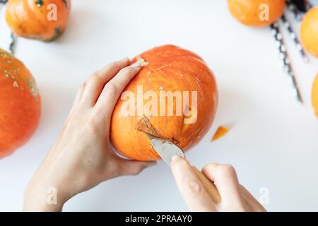 Halloween October 31st. The step-by-step process of carving a pumpkin. View from above. Stock Photo