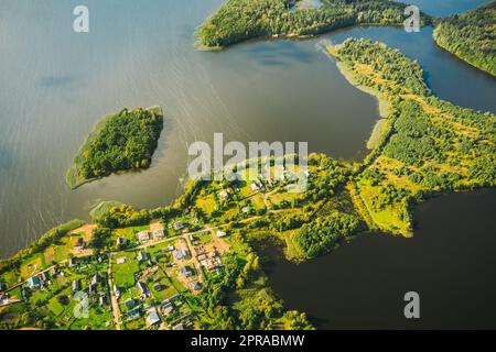 Lyepyel District, Lepel Lake, Beloozerny District, Vitebsk Region. Aerial View Of Residential Area With Houses In Countryside. Top View Of Island Pension Lode From High Attitude In Autumn Sunny Day. Bird's Eye View. Flat View Stock Photo