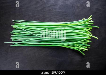 Bunch of chives isolated on black Stock Photo