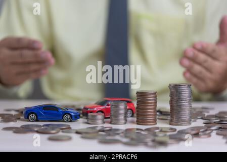 Coin money stack and car toy business investment accounting finance inflation growth.Saving money economics plan insurance concept. Stock Photo