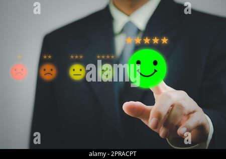 Man hand touch virtual screen emotion service and customer review feedback rating good and best five stars. Stock Photo