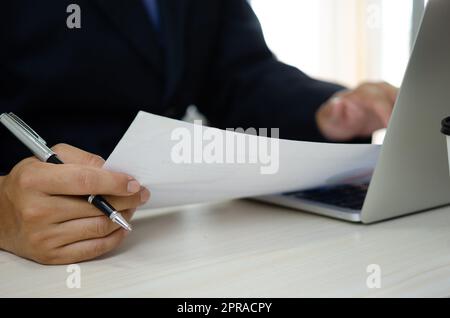 businessman holding documents charts statistical data investment analysis and tax accounting. Stock Photo