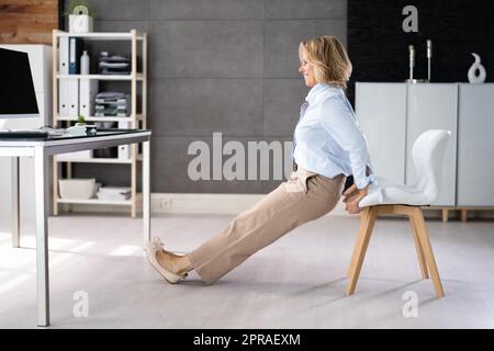 Chair Triceps Dip In Office. Workout Exercise Stock Photo