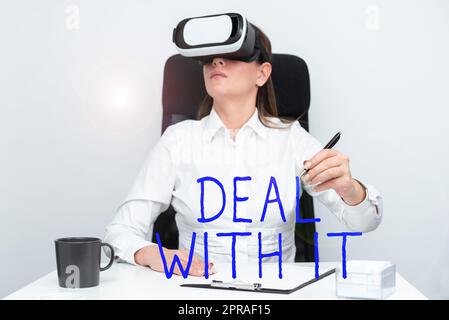 Text caption presenting Deal With It. Internet Concept Adapt to some particular situation and keep going forward Woman Wearing Goggles And Learning Skill With Virtual Reality Simulator. Stock Photo