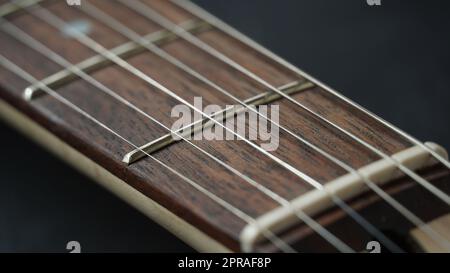 Guitar neck of black electric guitar on dark background Stock Photo