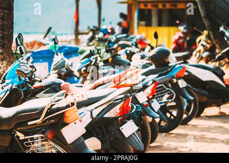 Motorbikes, motorcycles scooters parked in row in city street. Close up of details. Bikes Stock Photo