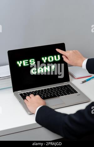 Conceptual caption Yes You Can. Business approach Positivity Encouragement Persuade Dare Confidence Uphold Woman Typing Updates On Lap Top And Pointing New Ideas With One Finger. Stock Photo