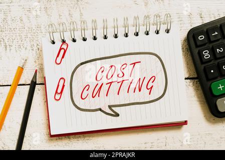 Text sign showing Cost Cutting. Concept meaning Measures implemented to reduced expenses and improved profit Speech Bubble With New Messages Written On Notebook On Floor. Stock Photo