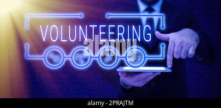 Text sign showing Volunteering. Concept meaning Provide services for no financial gain Willingly Oblige Businessman in suit holding tablet symbolizing successful teamwork. Stock Photo