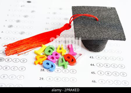 Math number with graduation gap hat on answer sheet test choice for learning Mathematic, education math concept. Stock Photo