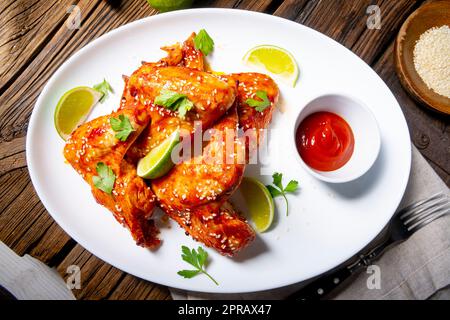 chicken wings with potato wedges and sezam. Stock Photo