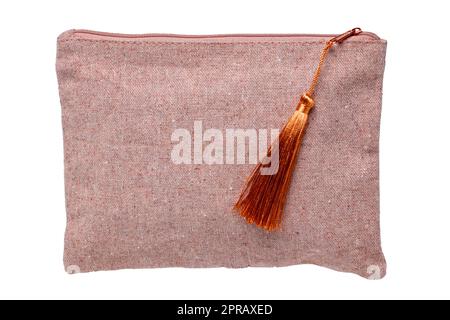 Cosmetic bags isolated. Close-up of a luxury cosmetic travel bag with zipper isolated on a white background. Used for essential equipment brushes for makeup and beauty products. Macro. Stock Photo