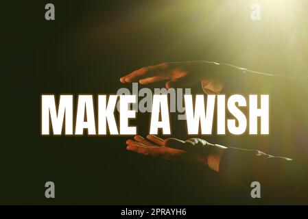 Inspiration showing sign Make A Wish. Business concept To have dreams desires about future events Be positive Businessman Presenting Important Informations Between Hands. Stock Photo