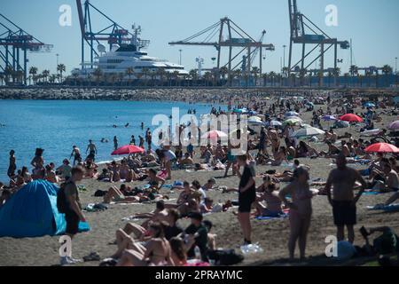 Malaga, Spain. 26th Apr, 2023. Bathers are seen sunbathing at 'La Malagueta' beach as they enjoy the good weather amid an unusual heat wave. Spain is experiencing an unusual episode of high temperatures in April, months before the beginning of summer. According to the Spanish State Meteorological Agency, temperatures of over 35 degrees will be reached in most of the country. (Photo by Jesus Merida/SOPA Images/Sipa USA) Credit: Sipa USA/Alamy Live News Stock Photo