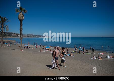 Malaga, Spain. 26th Apr, 2023. Bathers are seen walking at 'La Malagueta' beach as they enjoy the good weather amid an unusual heat wave. Spain is experiencing an unusual episode of high temperatures in April, months before the beginning of summer. According to the Spanish State Meteorological Agency, temperatures of over 35 degrees will be reached in most of the country. (Photo by Jesus Merida/SOPA Images/Sipa USA) Credit: Sipa USA/Alamy Live News Stock Photo