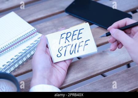 Text showing inspiration Free Stuff. Word Written on Any thing that you can have in a store that is not being paid Businesswoman Holding Pen And Notepad With Important Message. Stock Photo