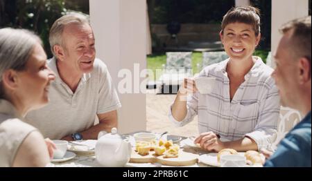 Time for an outdoor tea party. a family enjoying lunchtime tea in the garden together. Stock Photo