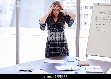 I dont know how Im going to handle this. a young businesswoman looking stressed in her office. Stock Photo