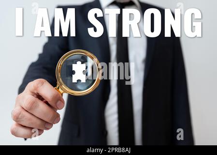 Text caption presenting I Am Strong. Business overview Have great strength being healthy powerful achieving everything Man Having Magnifying Glass To Point Important Informations. Stock Photo