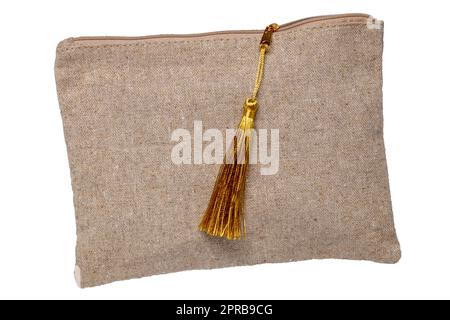 Cosmetic bags isolated. Close-up of a luxury cosmetic travel bag with zipper isolated on a white background. Used for essential equipment brushes for makeup and beauty products. Macro. Stock Photo