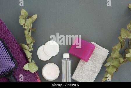 Invest in your skin, its going to represent you for a very long time. Overhead shot of various body care essentials on a grey background. Stock Photo
