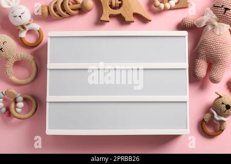 Blank letter board and different toys on pink background, flat lay. Mockup for design Stock Photo