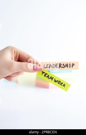 Team Leader Sticker front view leadership teamwork little stickers in female hands on white ...