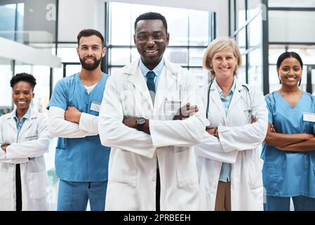 Multidisciplinary care is an integrated team approach to healthcare. Portrait of a group of medical practitioners standing together in a hospital. Stock Photo