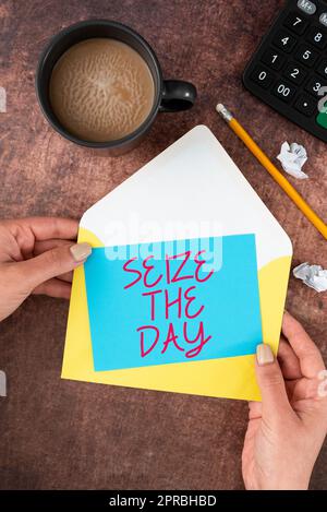 Text showing inspiration Seize The Day. Word Written on Embrace opportunities Have motivation inspiration optimism Woman Holding Blank Letter With Coffee And Stationery Over Wood. Stock Photo
