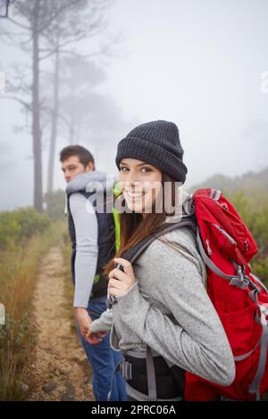 Its not where you go, but who you go with. Portrait of a beautiful young woman out hiking with her boyfriend. Stock Photo