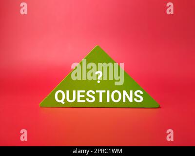 Colored wooden puzzle with the word QUESTION on red background Stock Photo