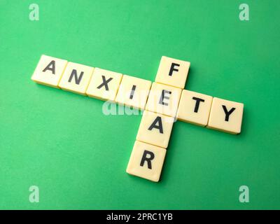 Toys word with the word ANXIETY FEAR on green background Stock Photo