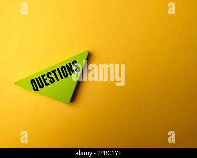 Colored wooden puzzle with the word QUESTION on yellow background Stock Photo