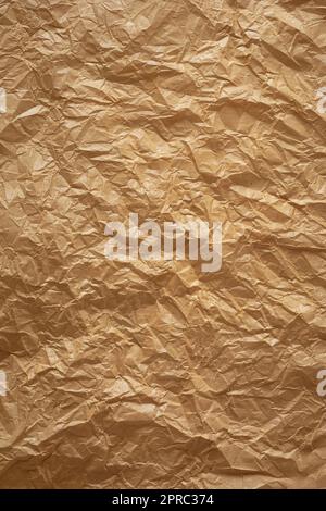 crumpled thin brown paper, brownish tone wrinkled recycle sheet of paper surface background texture, graphic resources with space for text Stock Photo