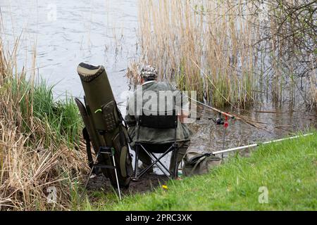 Carp fishing rods with reel set up on support system Stock Photo - Alamy