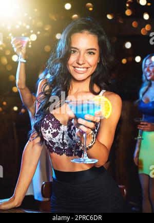 Confidence is the sexiest thing a woman can wear. a young woman partying in a nightclub. Stock Photo